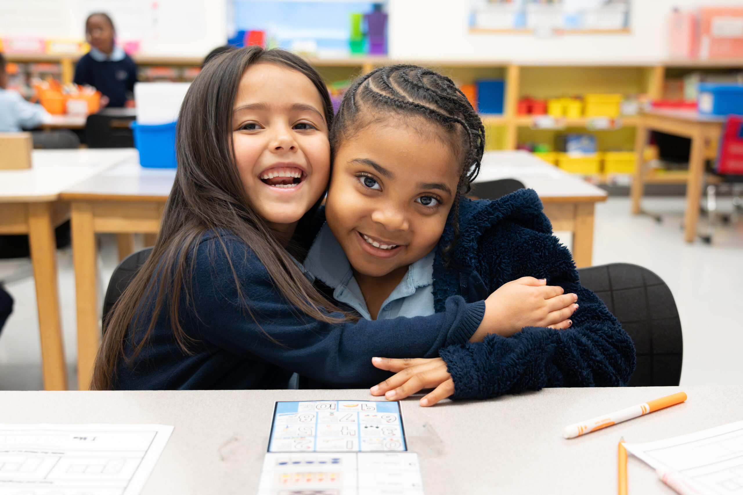 ES_K_students_hugging_smiling